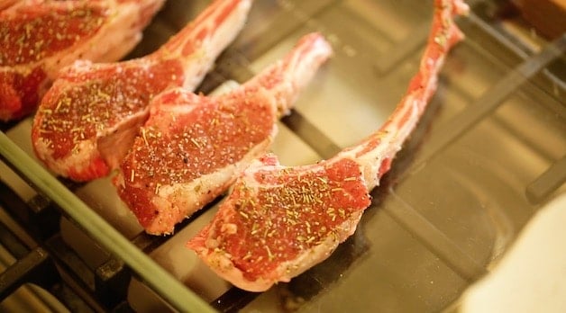 lamb chops seasoned in Pyrex Dish