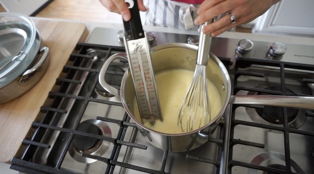 Heating Ice Cream custard base in saucepan with a candy thermometer 