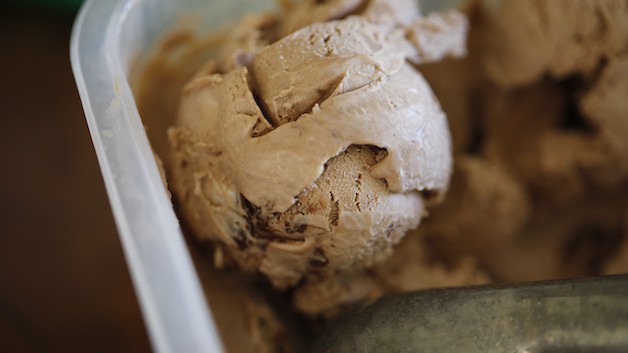A ball of Nutella Ice Cream scooped in a container