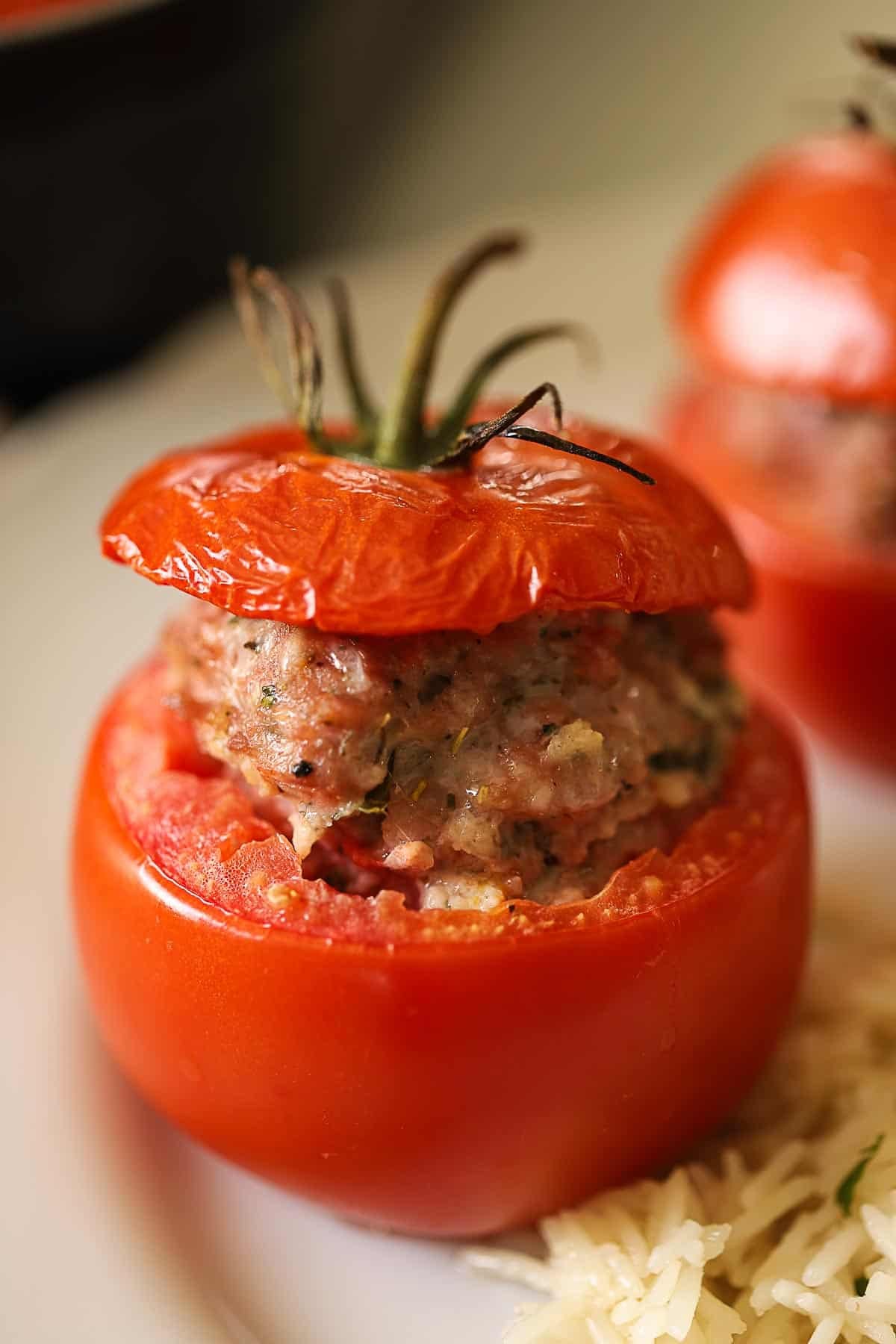 A stuffed tomato with a lid showing a vine rippened tomato.