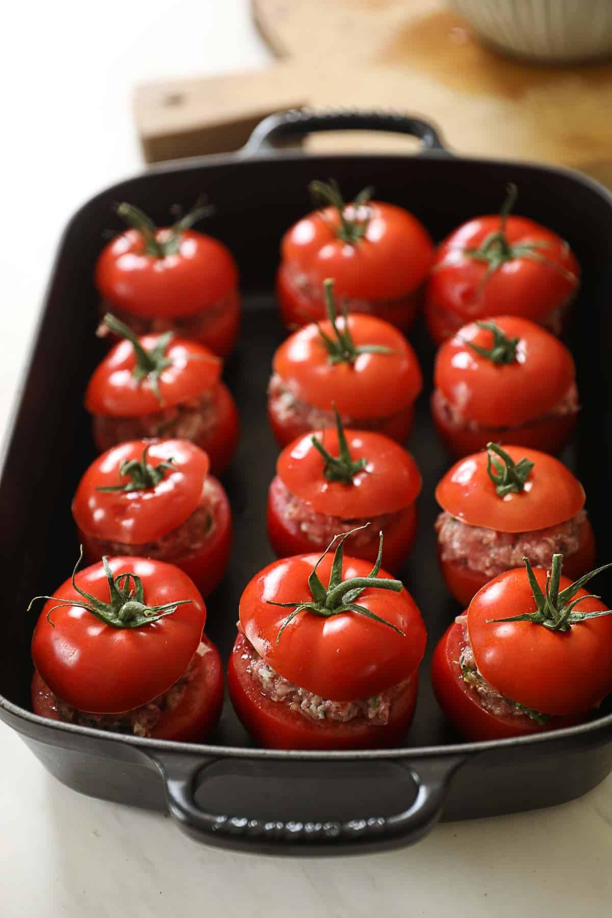 Stuffed Tomatoes in a large casserole ready for the oven.