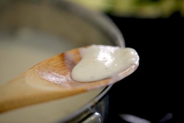 Bechamel Sauce on a wooden spoon