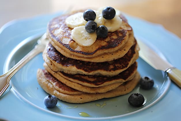 a stack of Oat Flour Pancakes topped with Blueberries and bananas on a blue plate