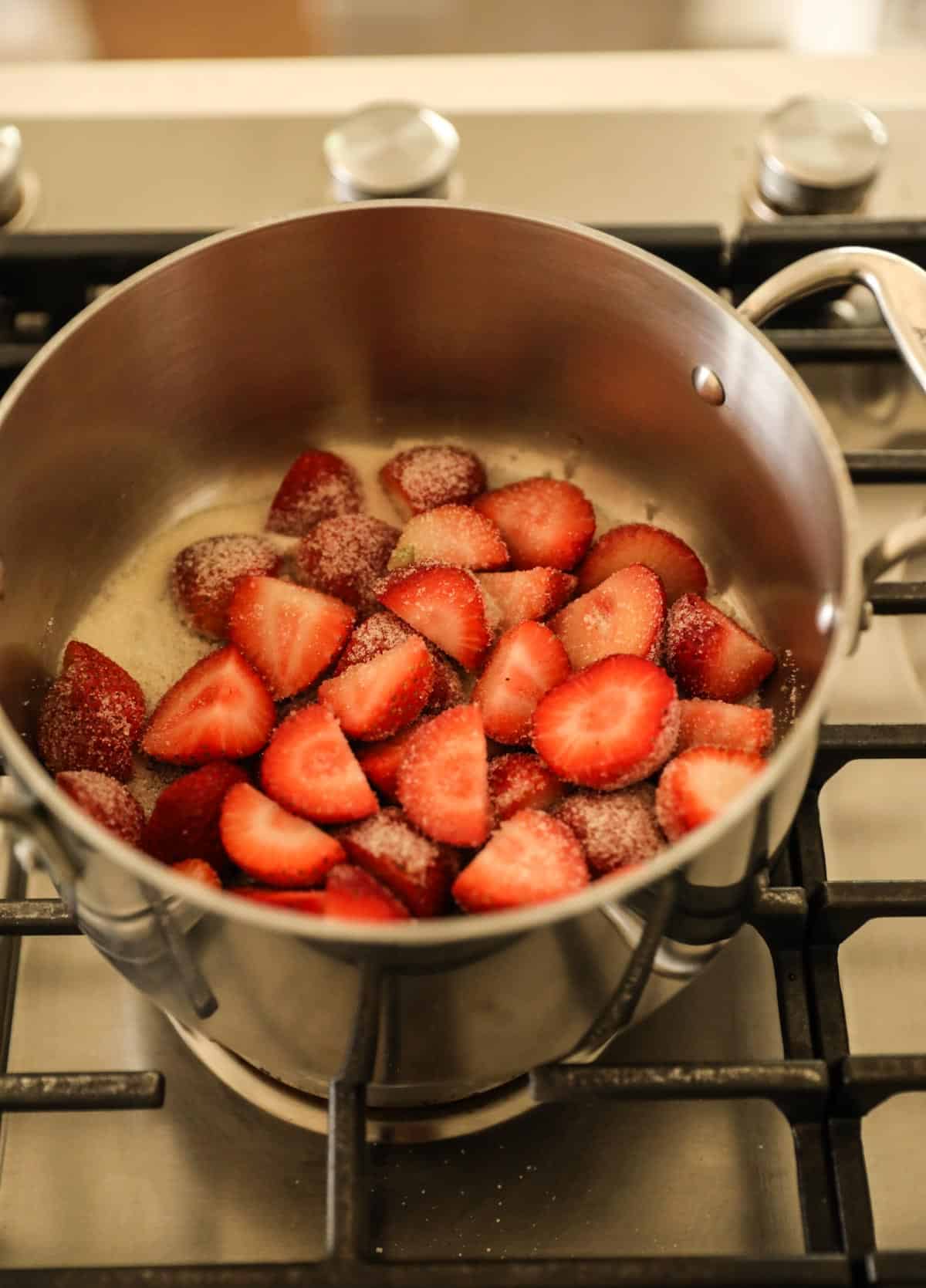 cut strawberries, sugar and water in a saucepan