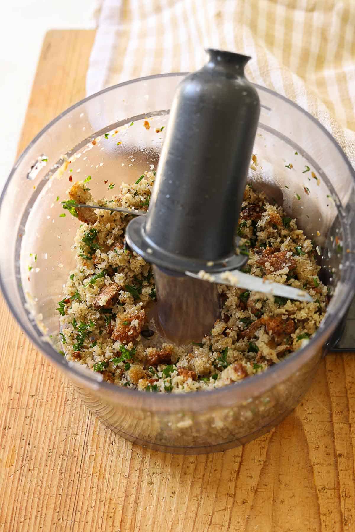 homemade breadcrumbs pulsed up in a food processor bowl.