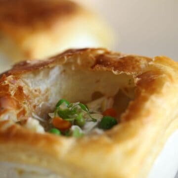 Chicken pot pie with puff pastry torn open to see interior
