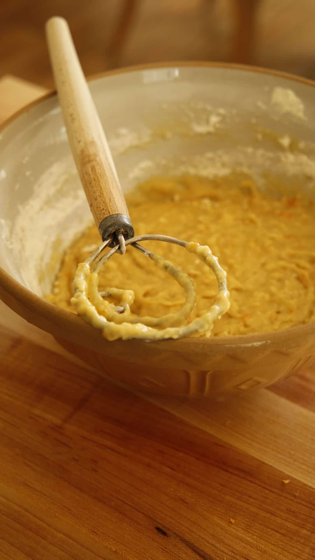Vertical Image of Muffin Batter in bowl with danish dough whisk resting