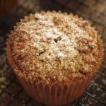 Vertical image of powdered sugar on a crumb muffin