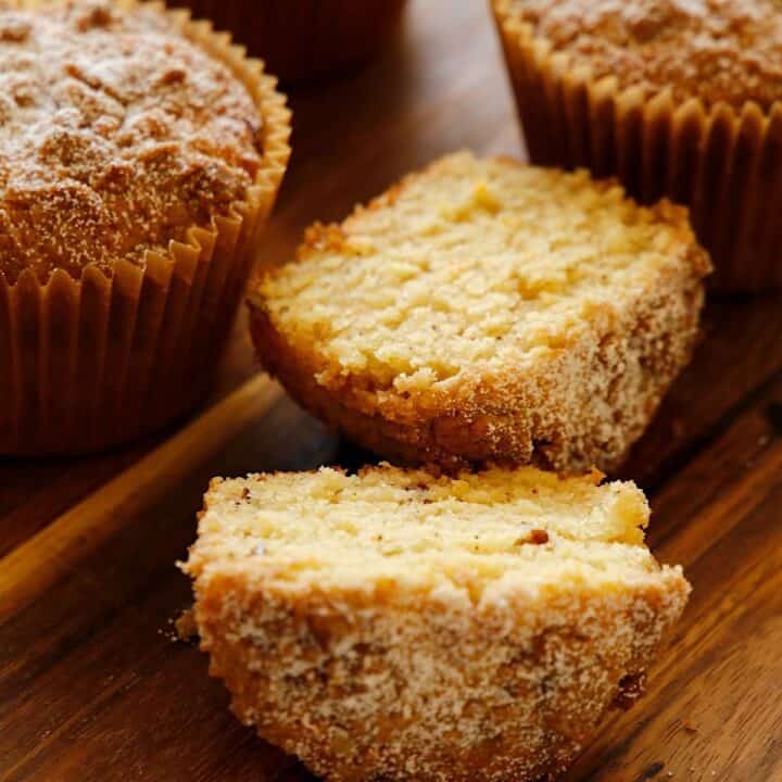 Orange Pecan Muffins sliced and whole on a cutting board