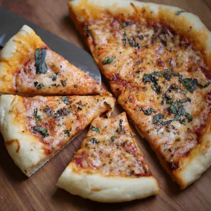 Homemade Pizza sliced on a board into slices