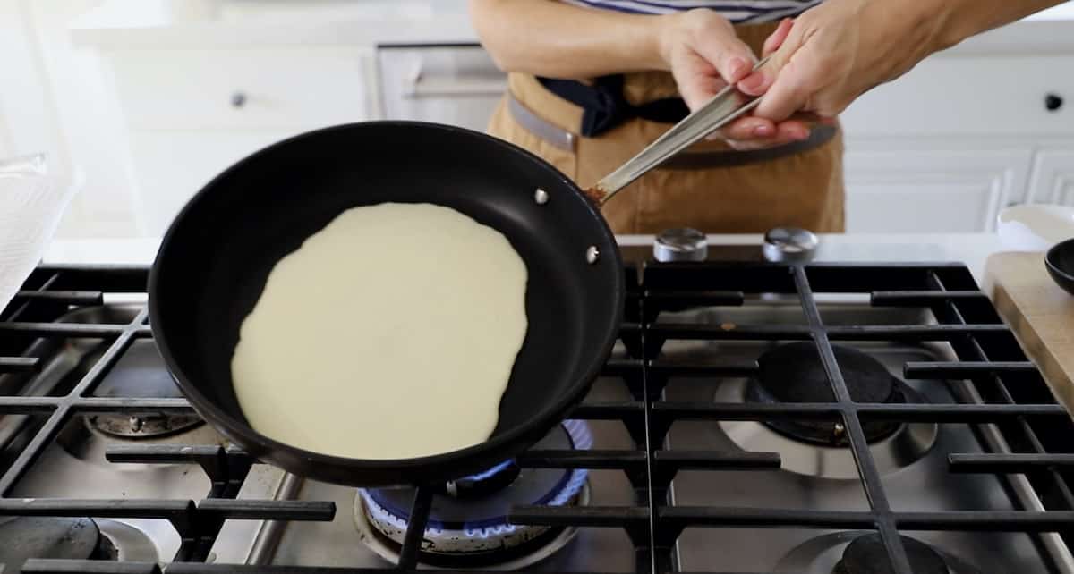 Crepe batter swirling around in a crepe pan 