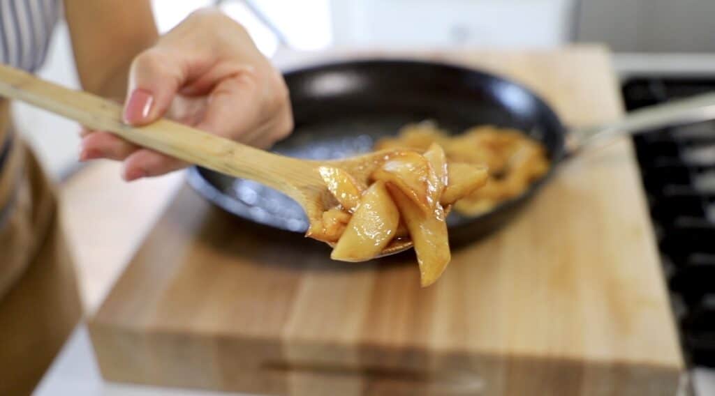 Carmelized apples on a wooden spoon
