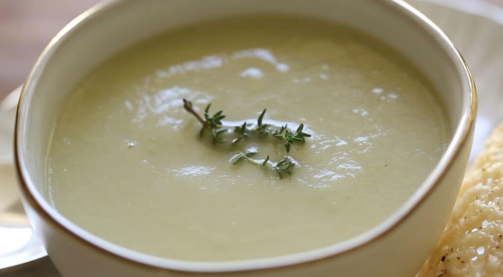 Close up of cream of celery Soup garnished with Thyme