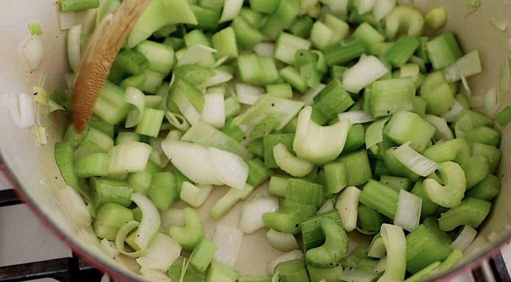 celery, onuons and leeks in a pot cooking