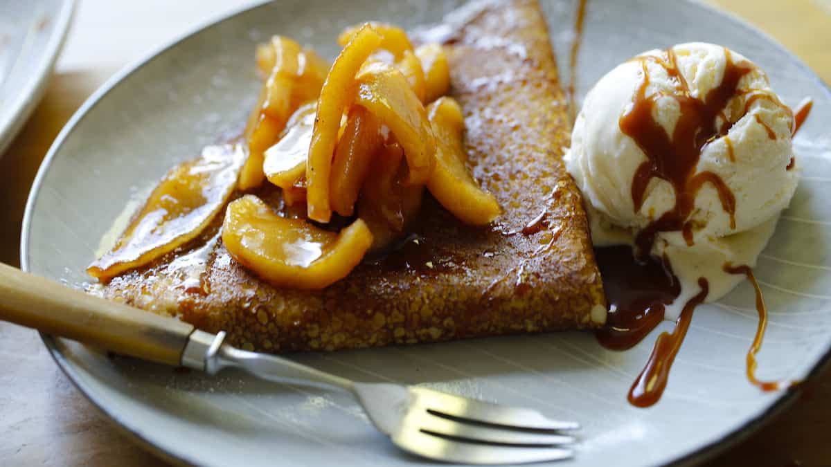 Crepe on a plate with apples and ic cream