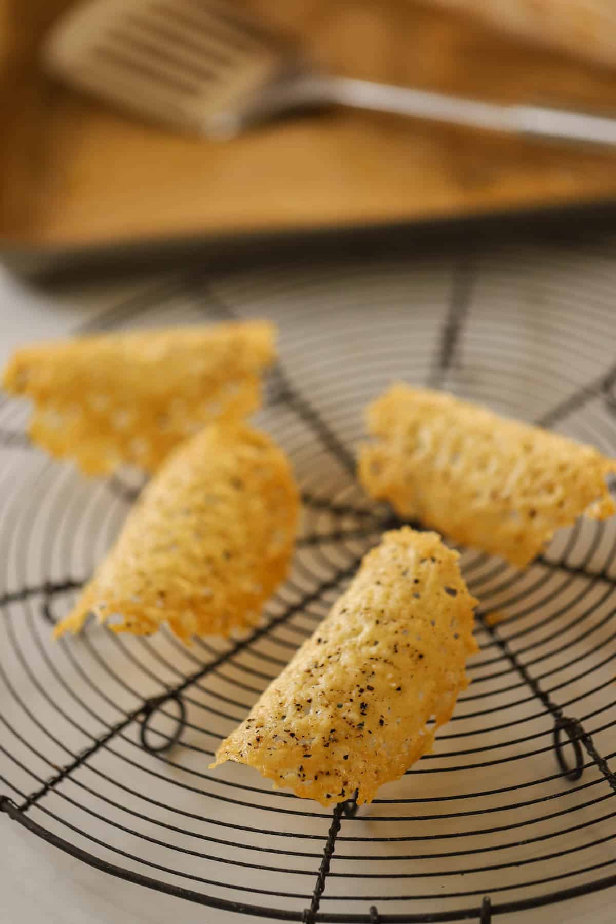 Parmesan tuiles on a cooling rack.