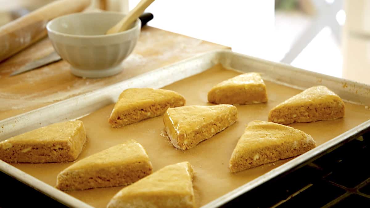 scone triangles on a baking sheet ready for the egg wash