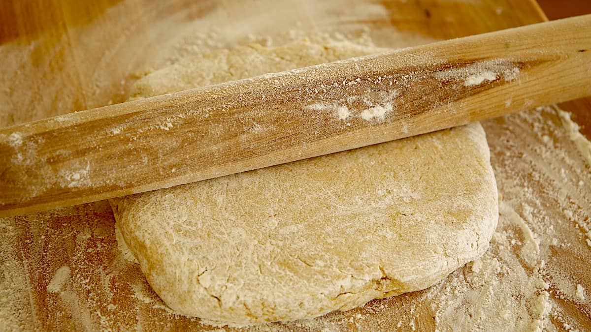 scone dough and rolling pin, forming dough into a square