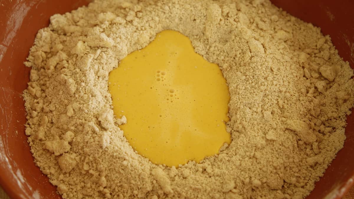 a bowl with dry ingredients with a well created for wet ingredients