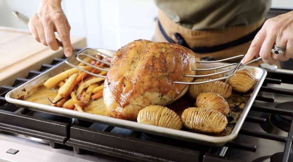 Turkey Forks lifting roasted Turkey off sheet pan 