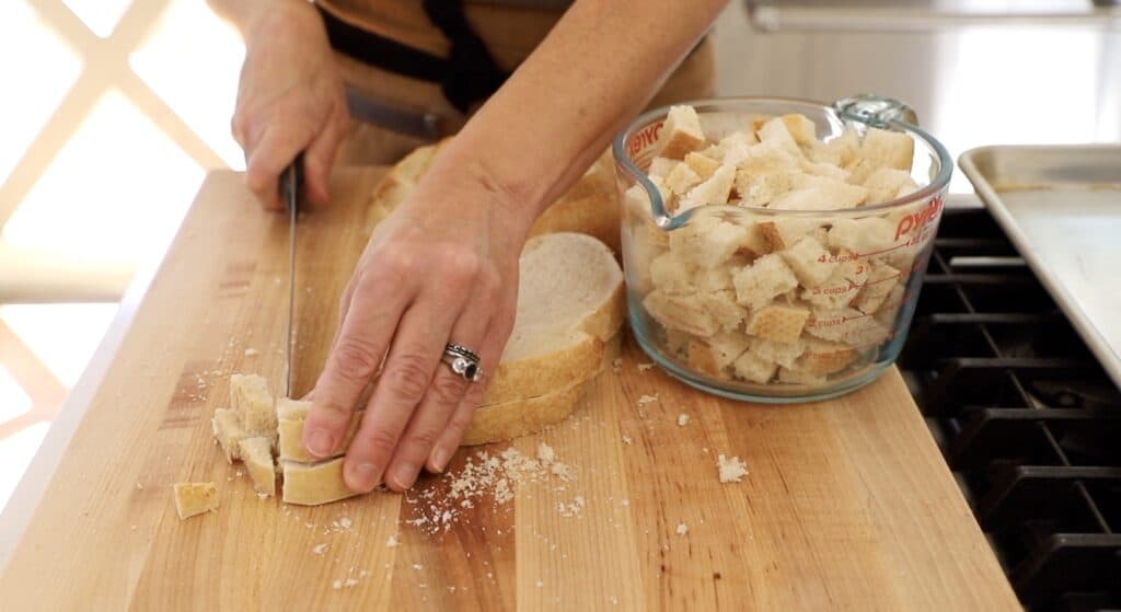 slicing sourdough bread into bread cubes