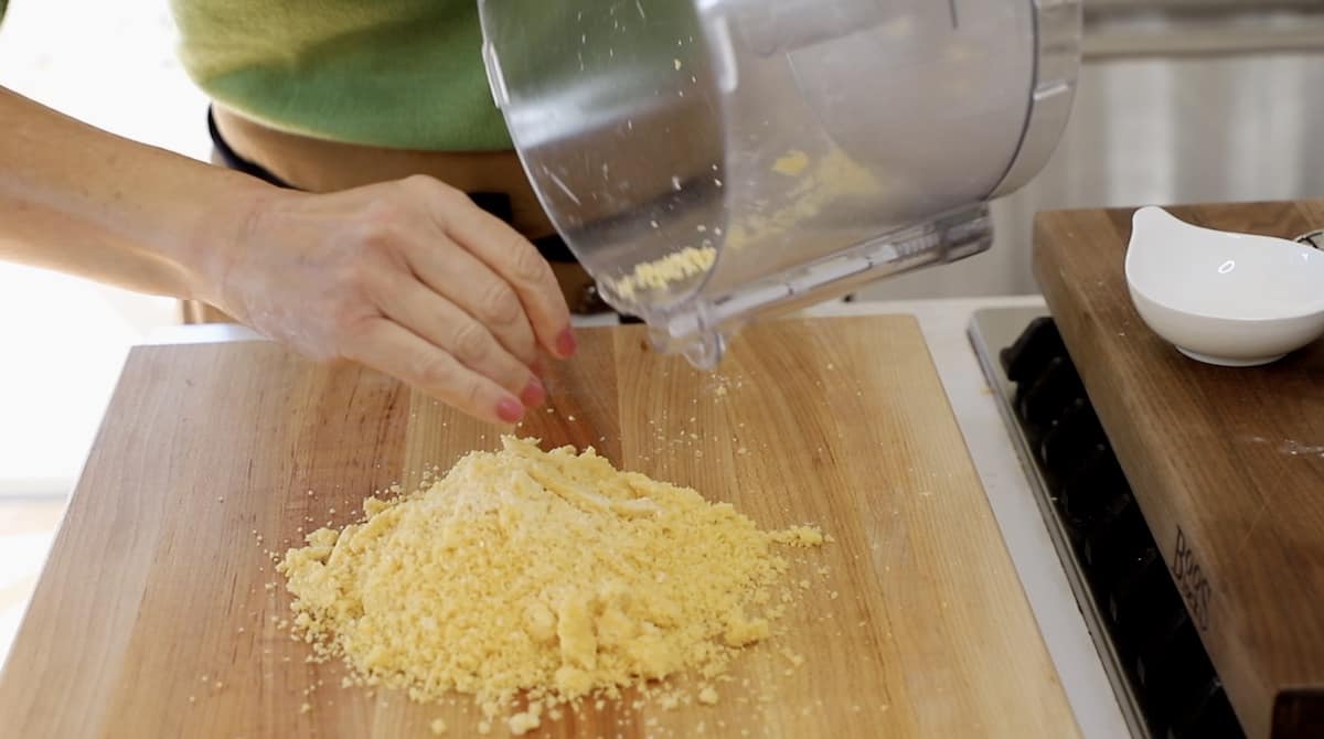 transfering coin dough crumble from a fgood processor to a cutting board