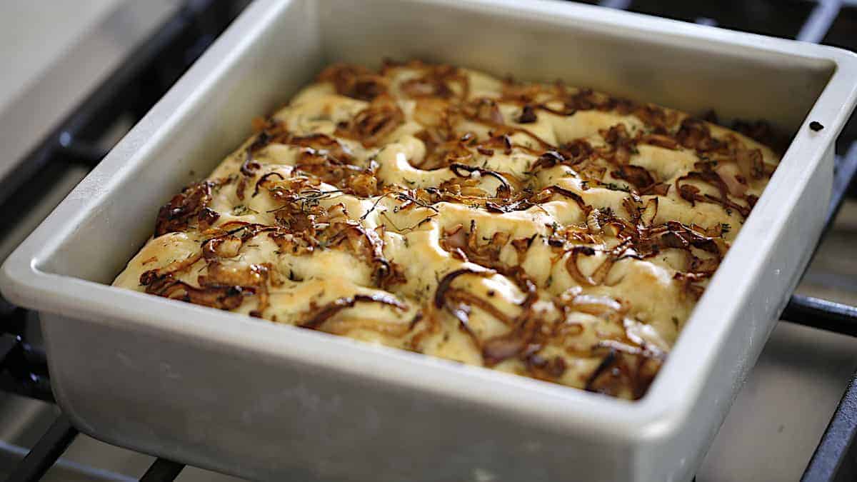 Freshly baked foccacia cooling on a cooktop