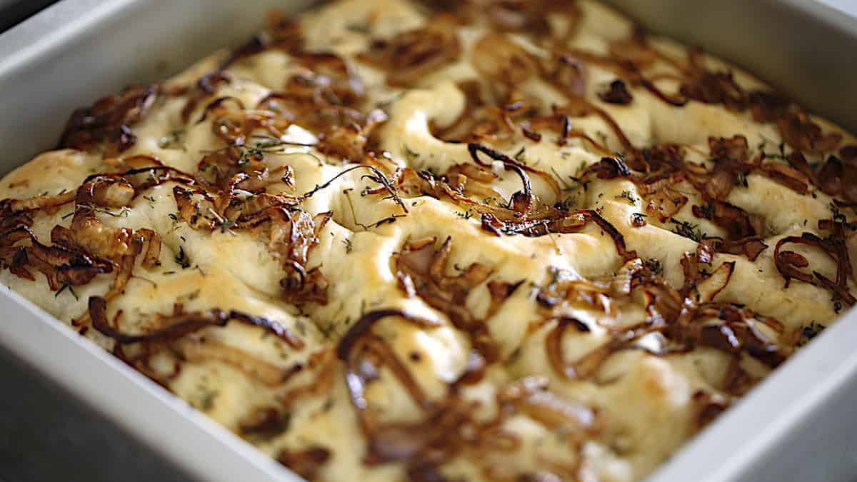 freshly baked focaccia bread topped with shallots and thyme