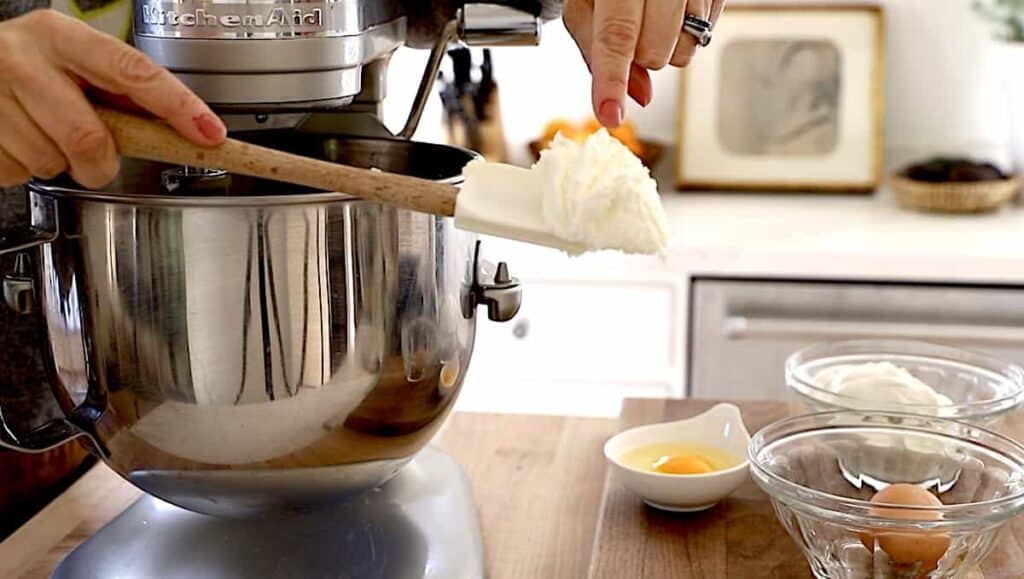 a person showing texture of the fluffy butter and sugar on a spatula