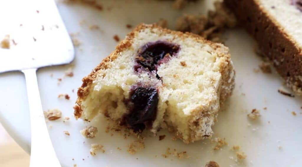 a slice of sour cherry crumb cake with a bite taken out