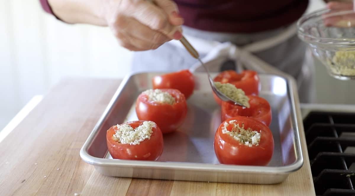 Filling cored tomatoes with bread crumb mixture
