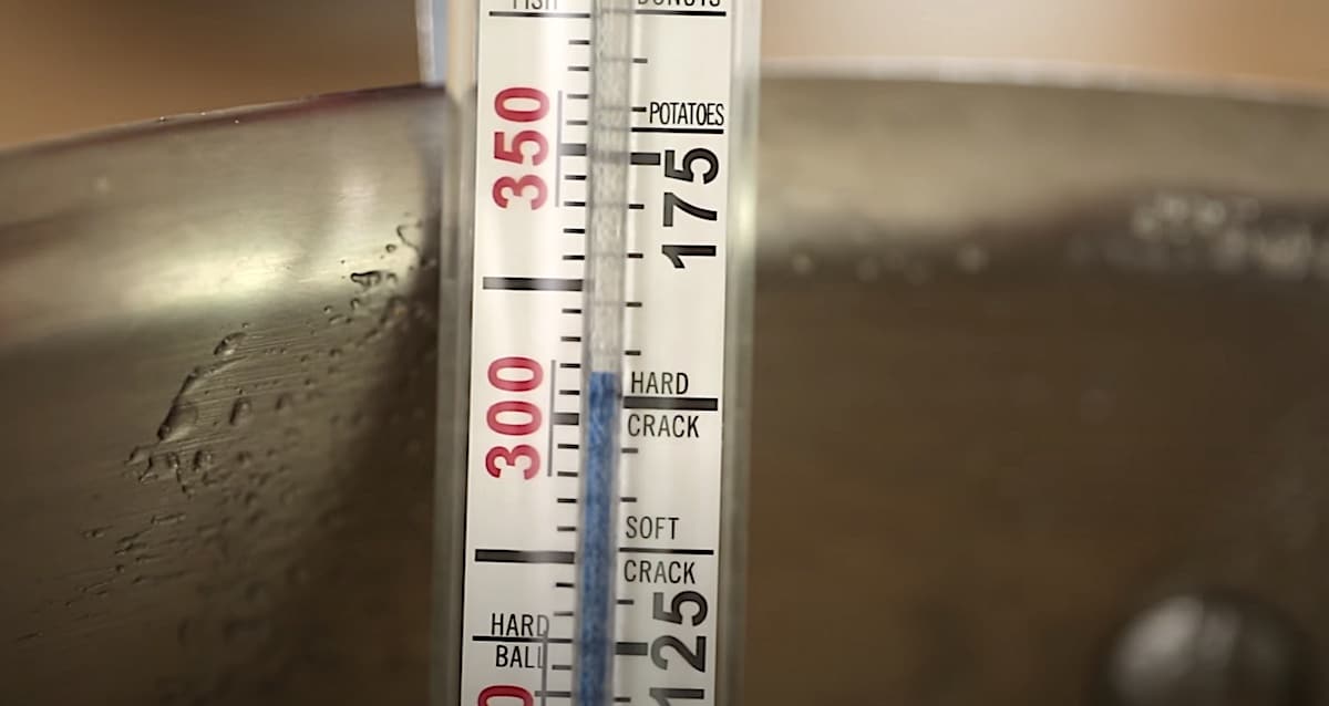 a candy thermometer registering at 302F for a hard crack