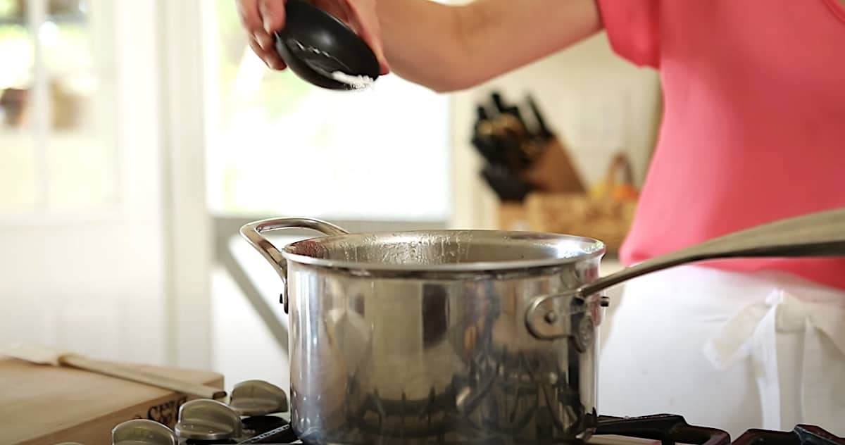 adding baking soda to a pot