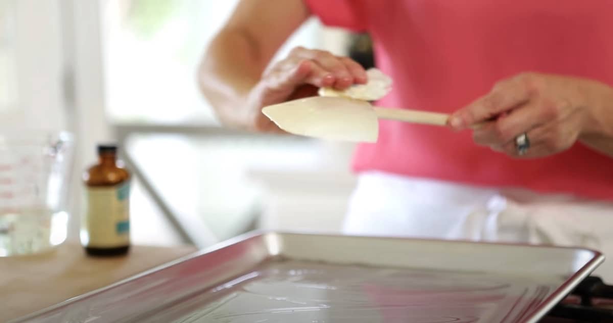 a person greasing a heat-safe spatula