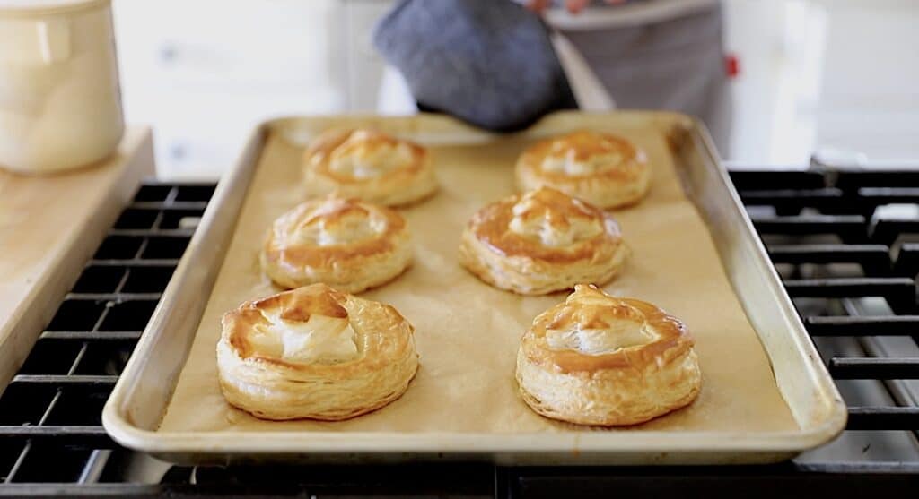 freshly baked puff pastry rounds on a cooktop