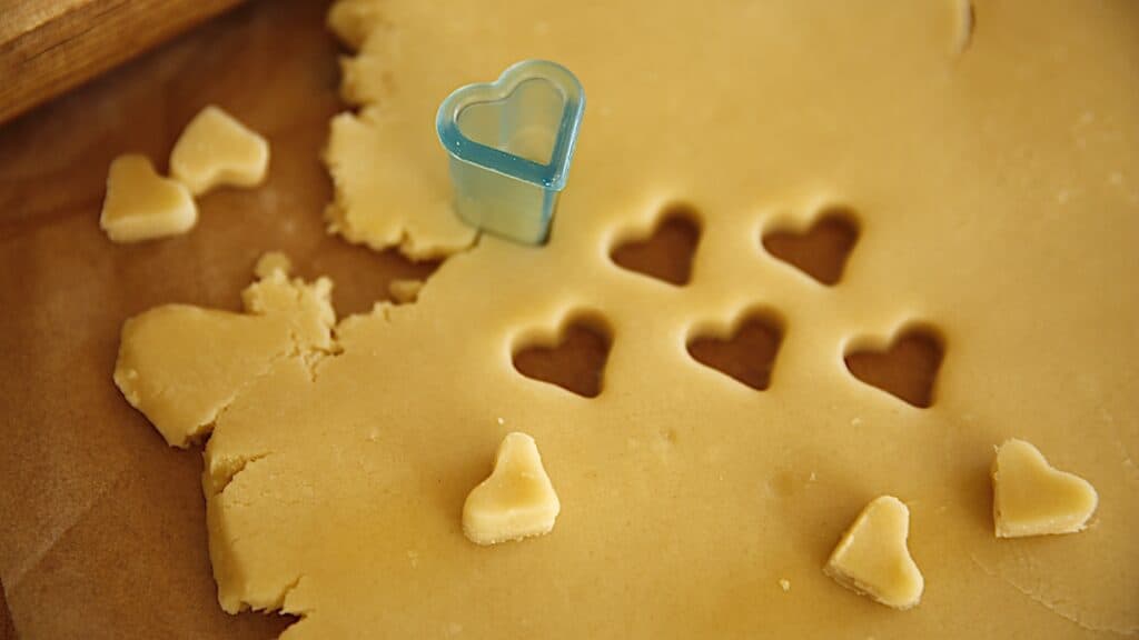 small hearts cut from sugar cookie dough
