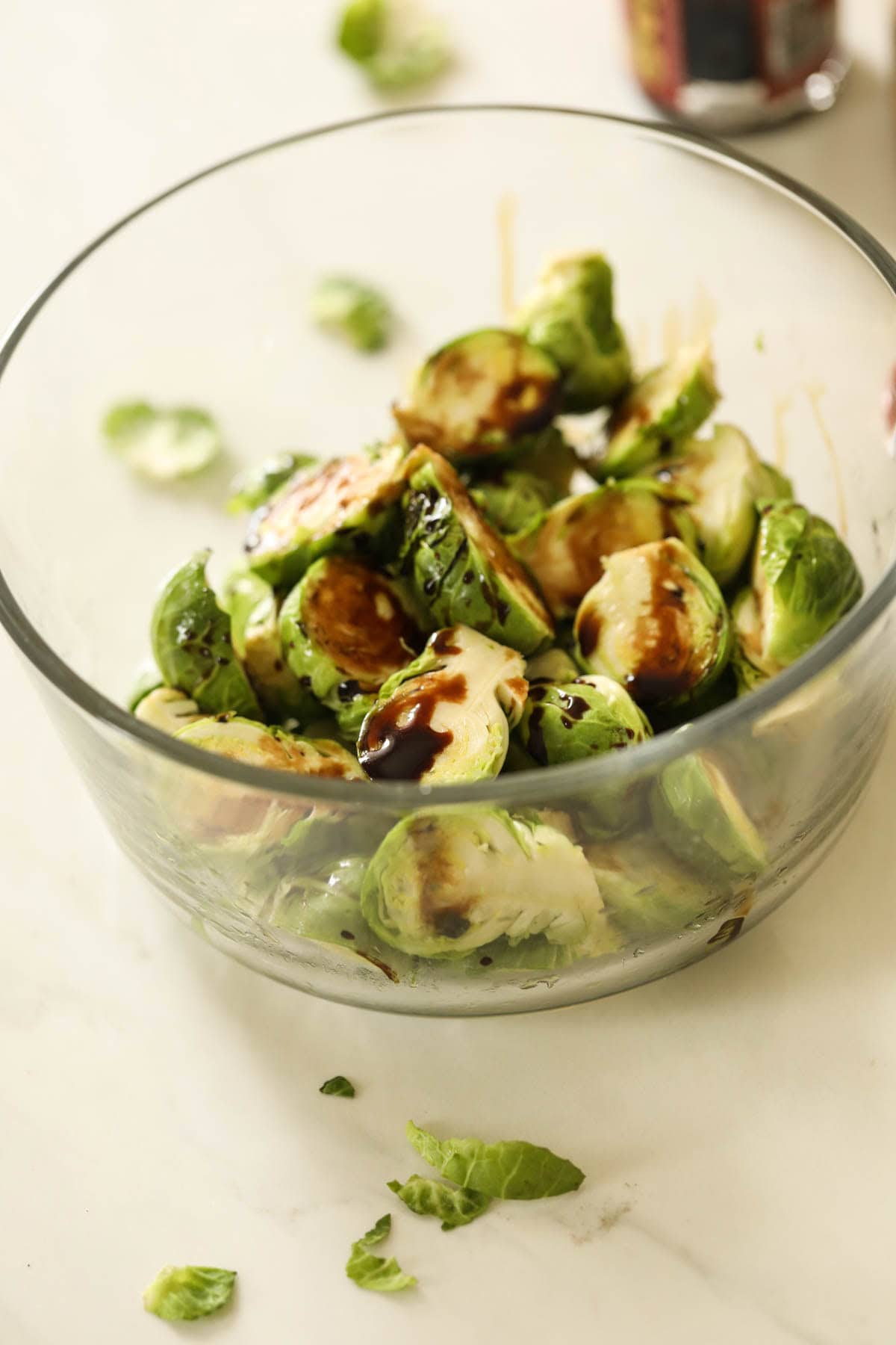 Brussel sprouts in a bowl with balsamic vinegar.