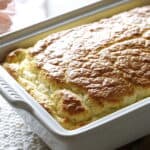 Vertical image of a breakfast souffle in a white casserole dish