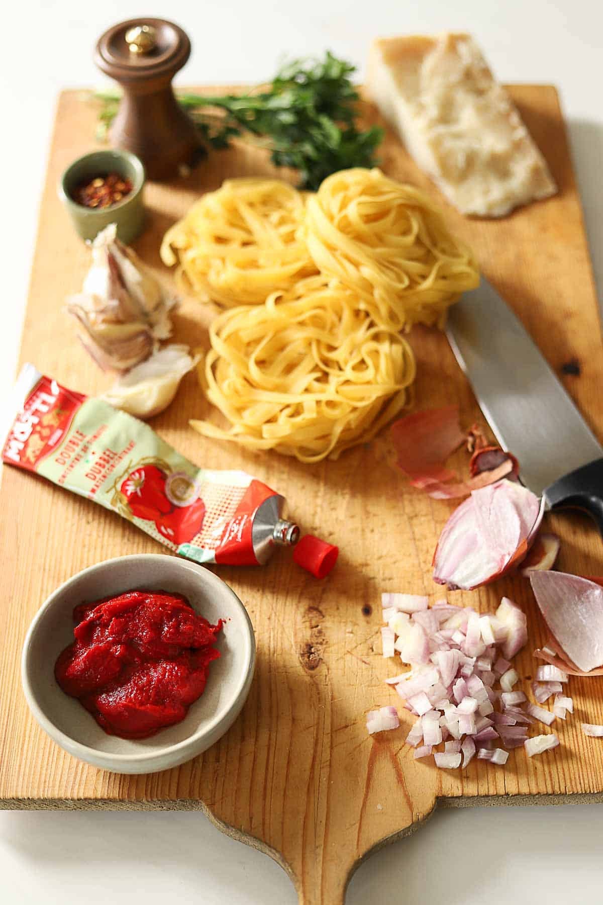 Pasta, Tomato Paste, Shallots, a wedge of parmesan and parsley.