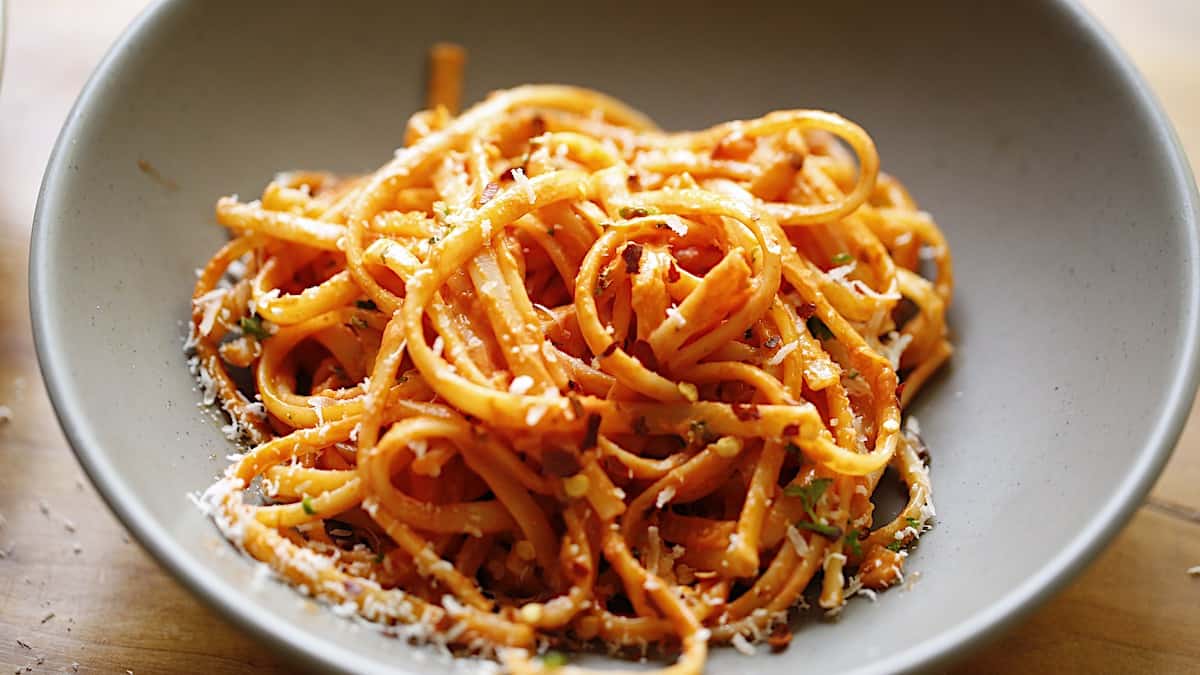 An individual serving of linguine tossed with a pink sauce