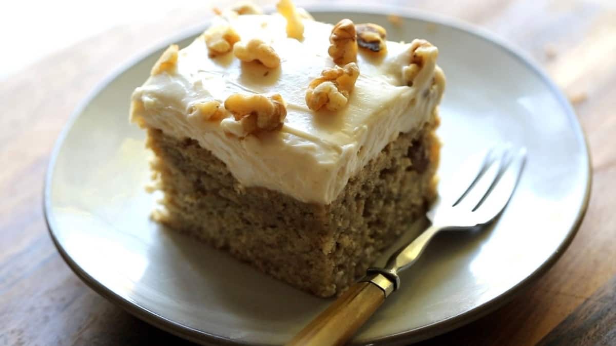 a slice of banana cake on a small plate with fork