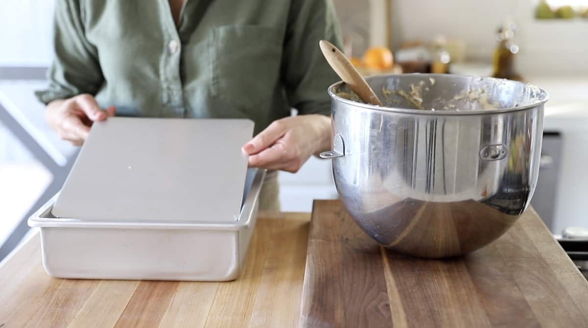 a person showing a removable bottom cake pan