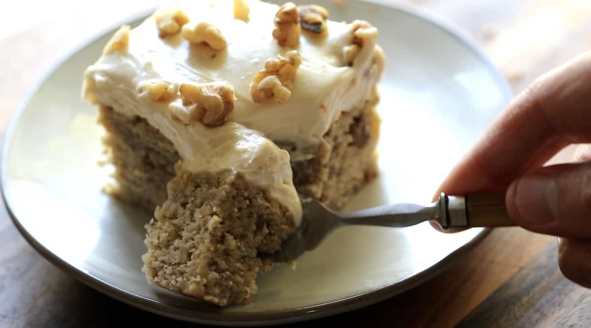 a person taking a bite out of a slice of cake to show the texture