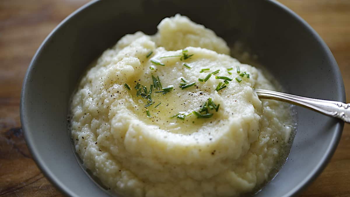 Cauliflower Mash in a bowl with butter and chives