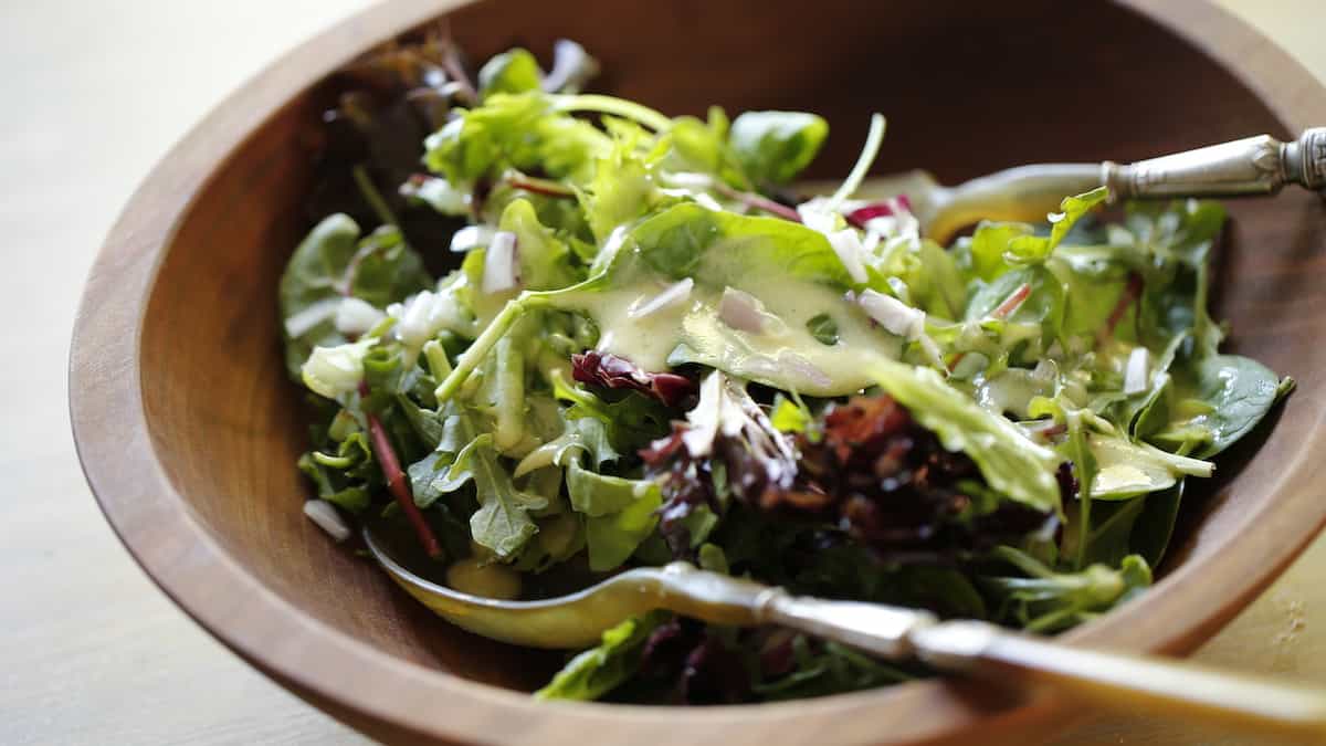 a bowl of tossed greens with a french vinaigrette