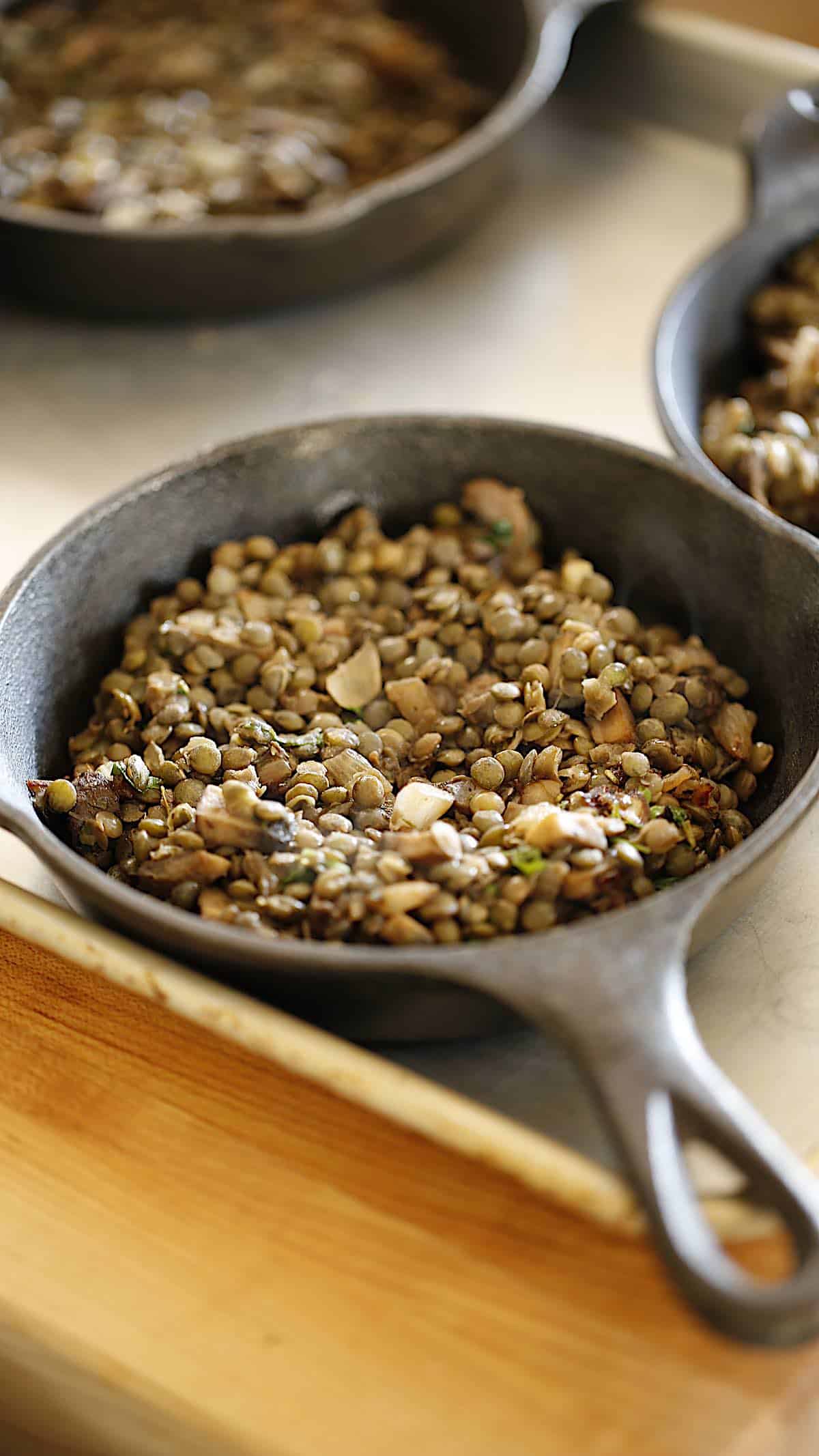 Cooked lentil and mushroom mixture in mini cast-iron skillets