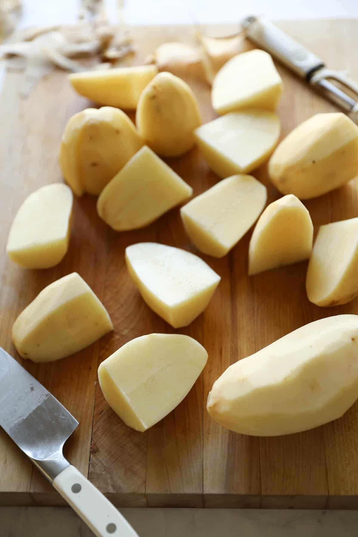 Peeled and cut potatoes on a board