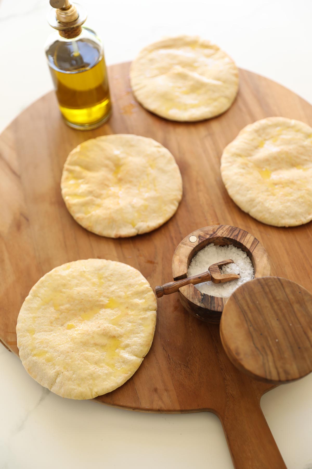 pita on a cutting board with oil and salt