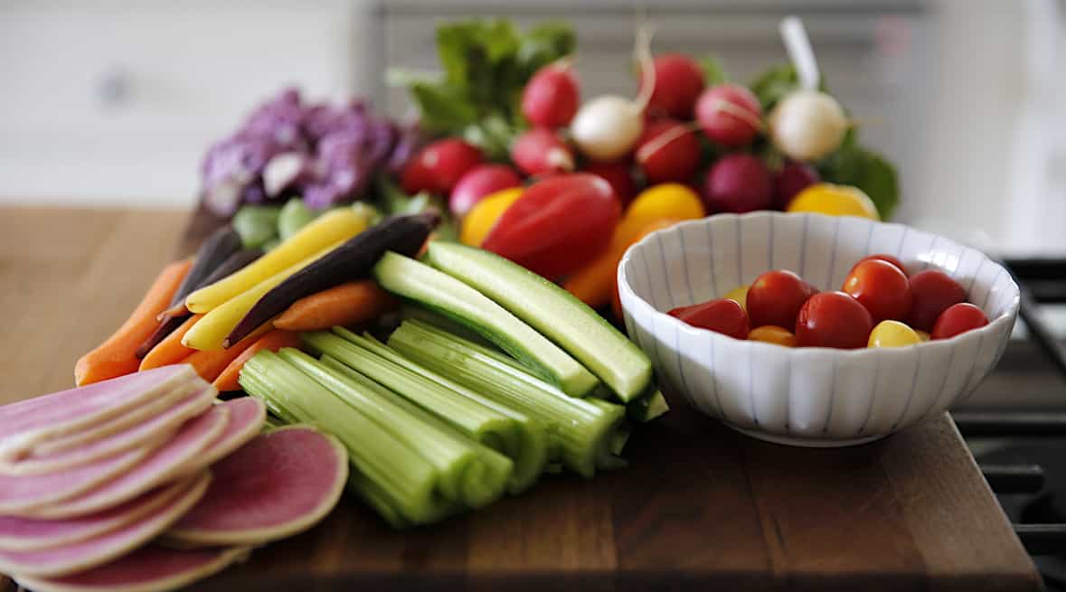 a cutting board with colorful vegetables on it