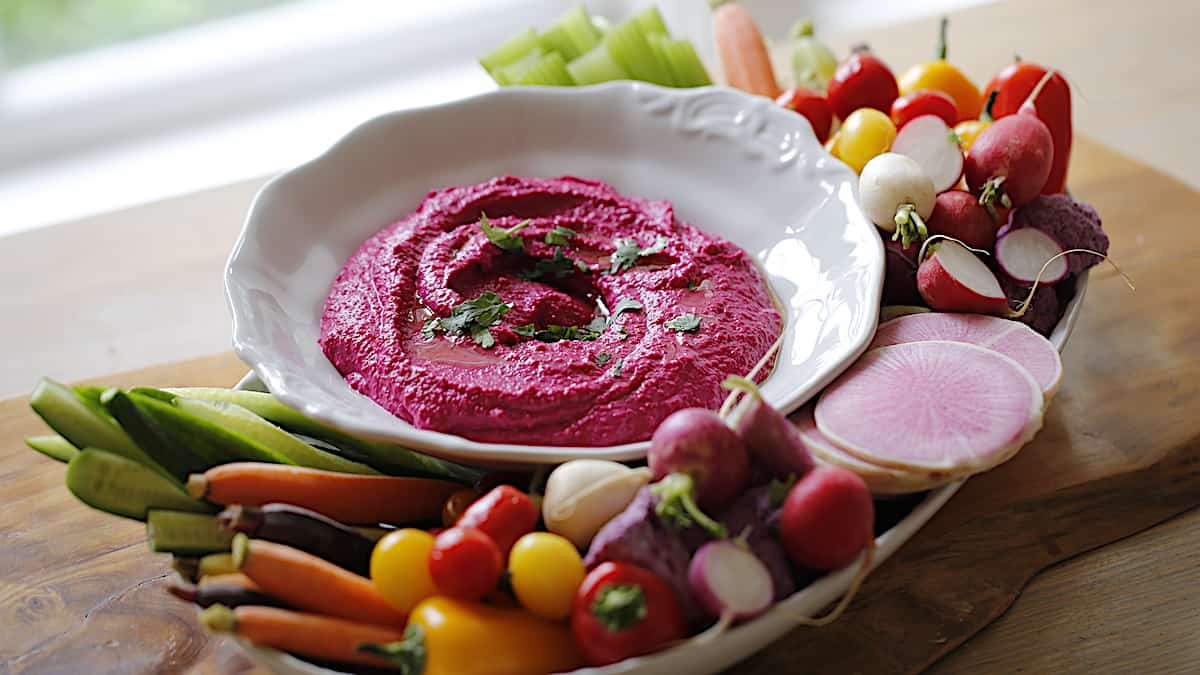 Beetroot hummus platter with a selection of spring vegetables